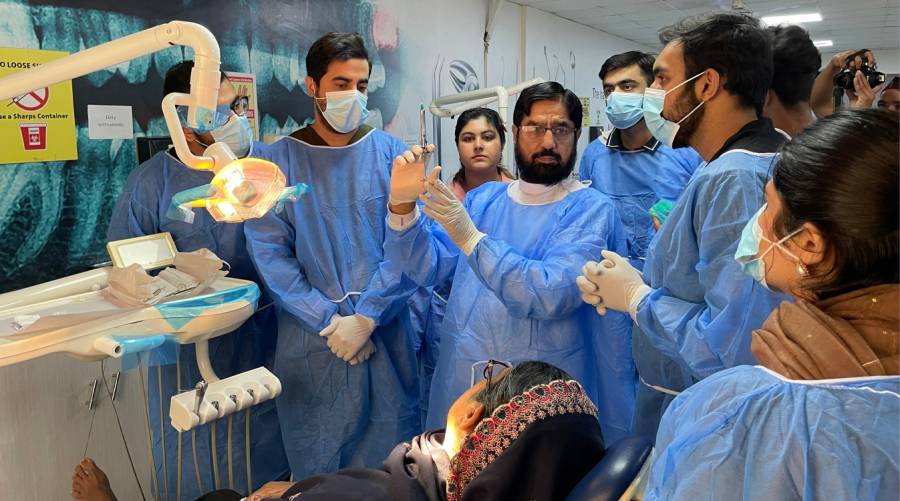 Dental professionals attending hands-on exodontia workshop at IADSR guided by Prof. Arshad Mahmood Malik.