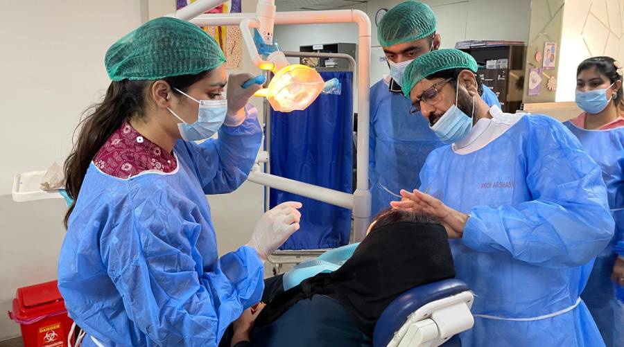 Dental professionals attending hands-on exodontia workshop at IADSR guided by Prof. Arshad Mahmood Malik.