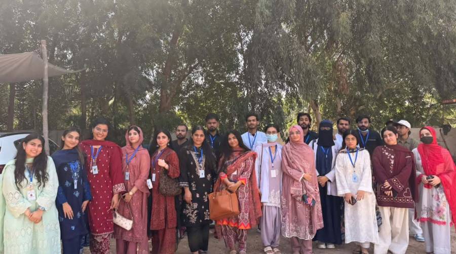 Healthcare professionals and student volunteers providing free dental and medical services at a community camp in Abdul Karim Village, Sanghar