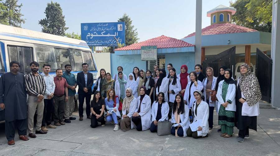 Dental professionals and house officers conduct oral examinations and demonstrate brushing techniques during a dental camp for visually impaired students in Islamabad.
